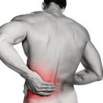 Black and white photo of a muscular man with a backache. Red selective color further illustrates pain. Clipping path included so image can be easily transferred to a different colored background.
